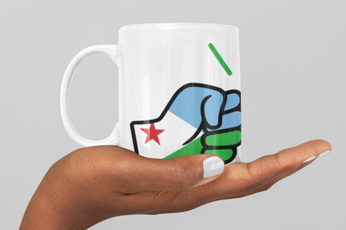 White ceramic coffee mug with a logo of We Run Tings Djibouti. Held by a hand against a gray background