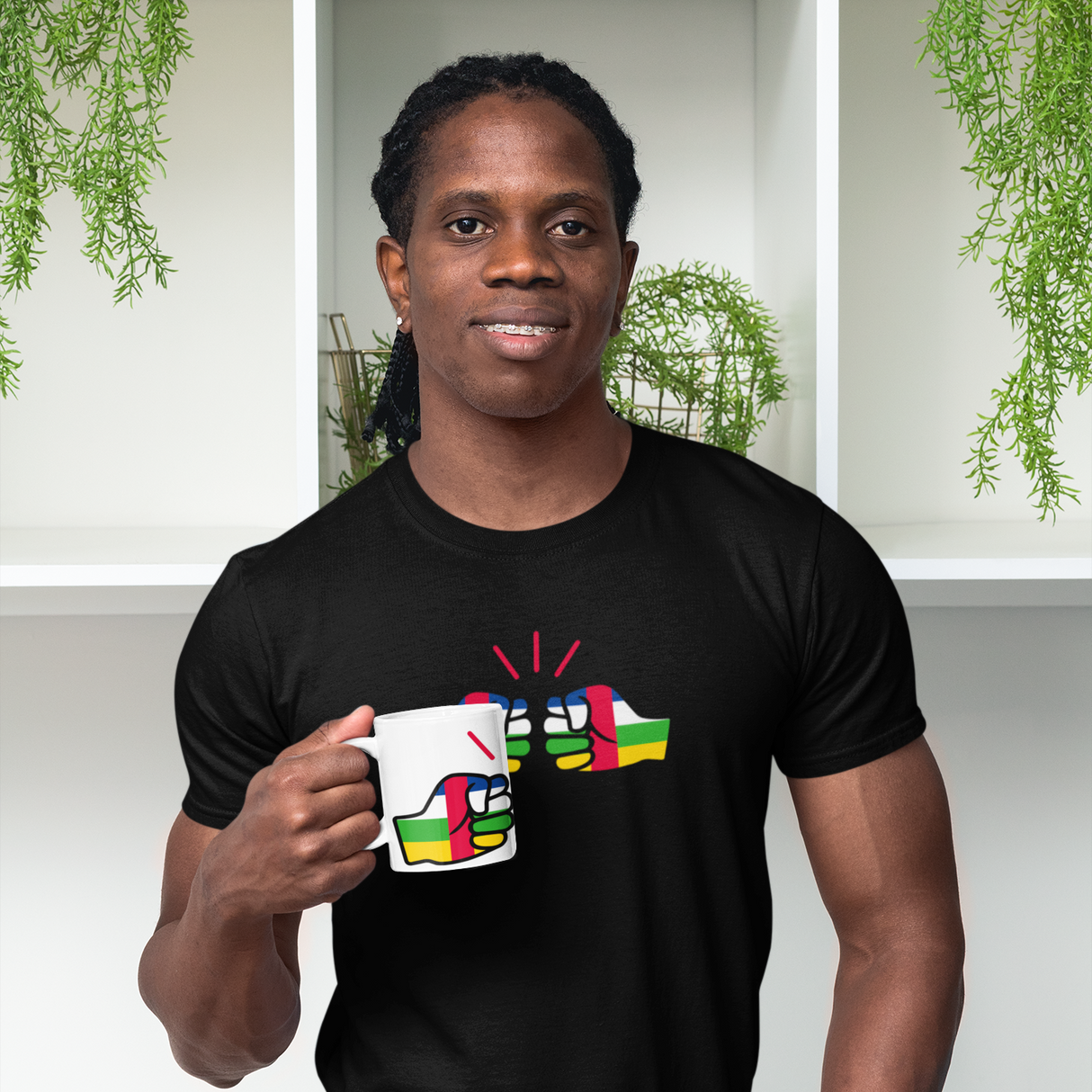 Man holding a white We Run Tings Central African Republic (CAR) Mug and wearing a matching black t-shirt with brand logo.