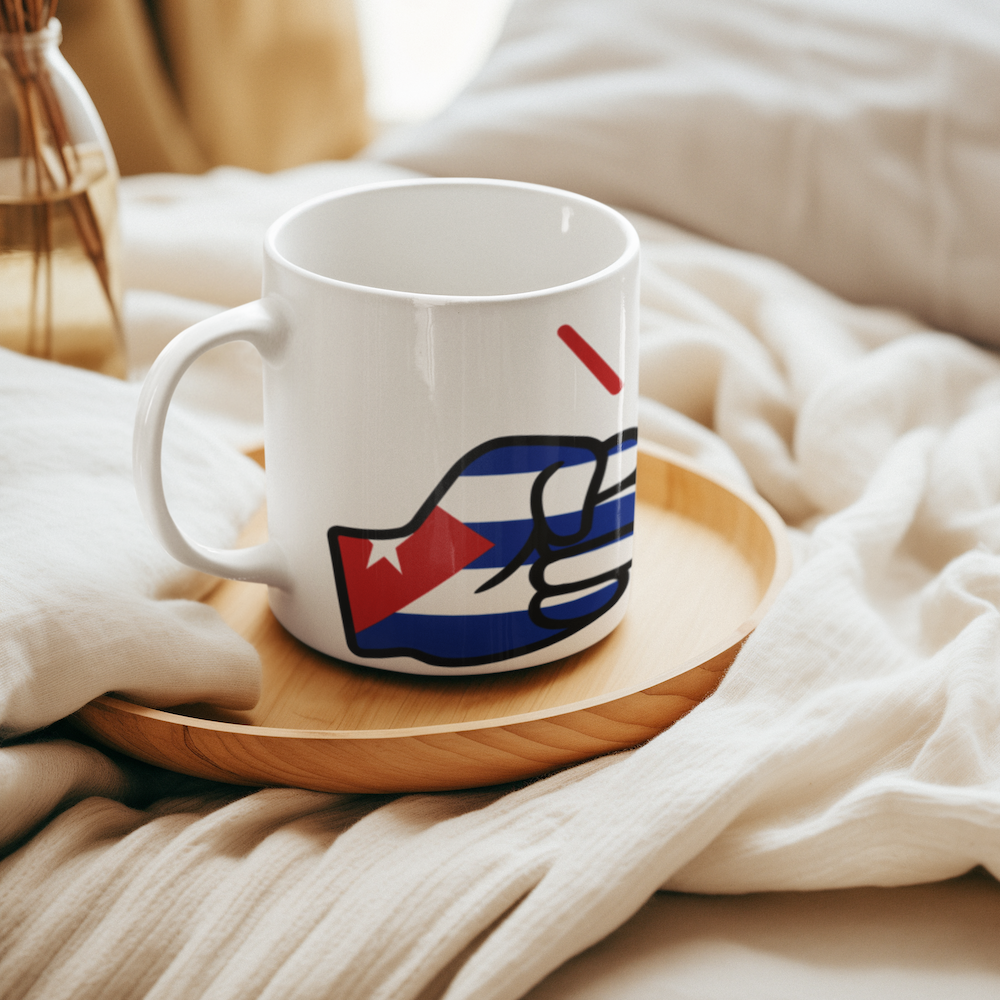 White mug with a colorful design on a wooden tray on a bed