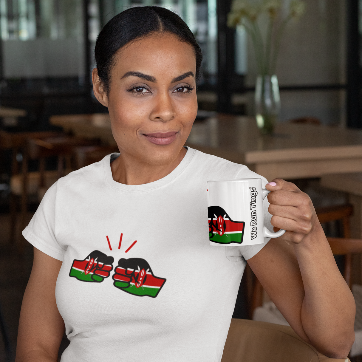 Woman holding a We Run Tings Kenya themed coffee mug with a design of the Kenyan flag, sitting in a casual setting.
