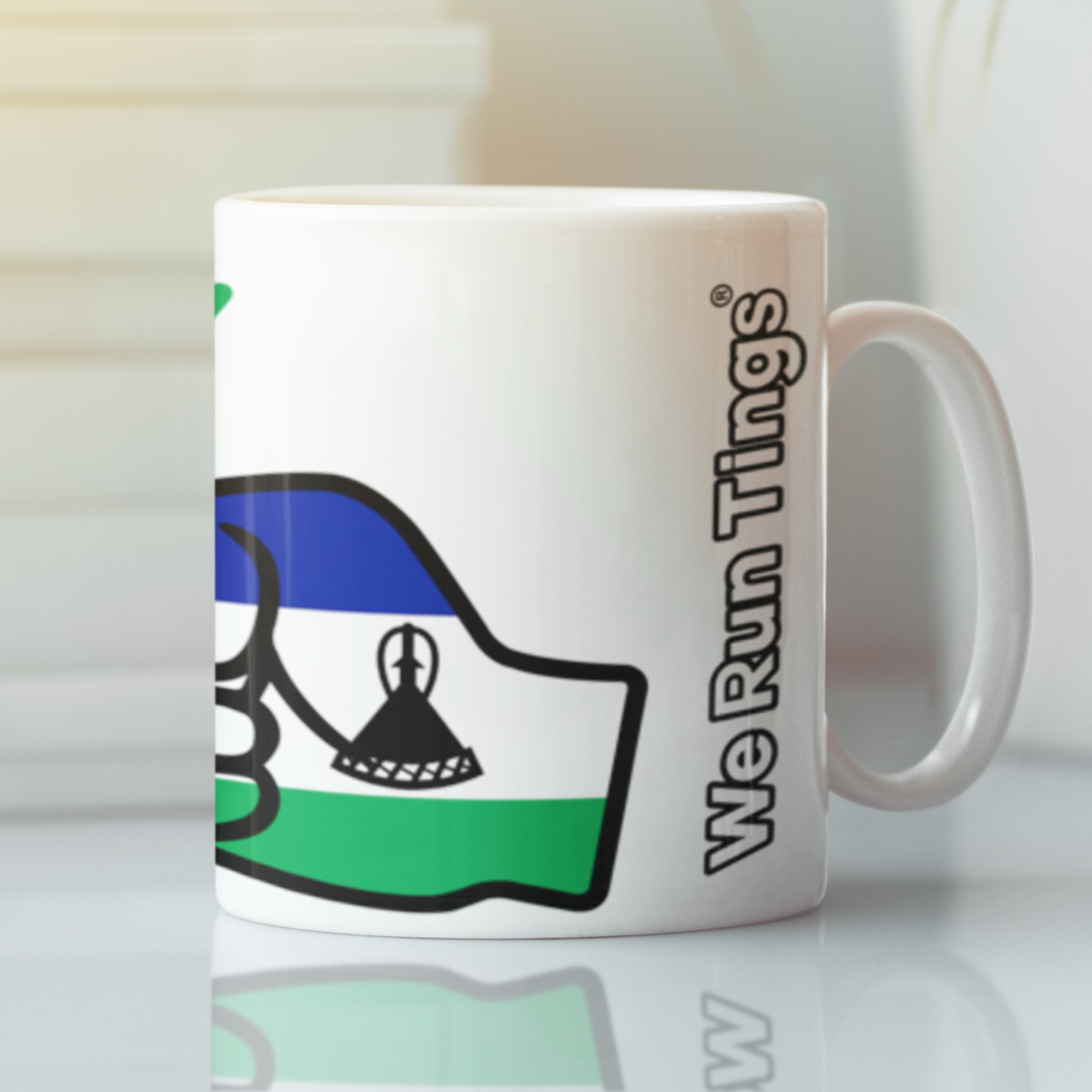 We Run Tings Lesotho ceramic coffee mug with a design and text on a light background