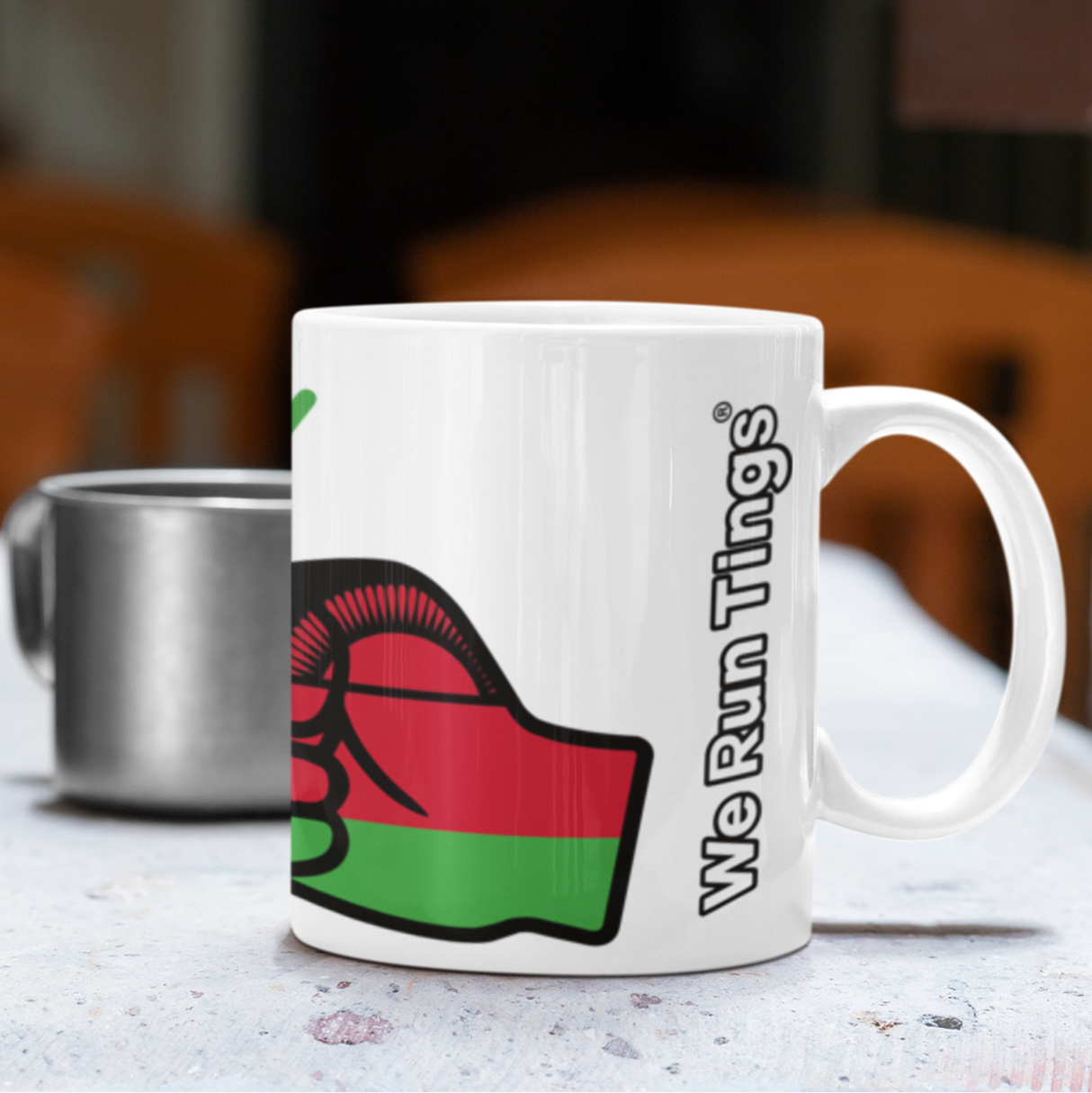 White We Run Tings Malawi ceramic tea, mug , cup with a logo and text 'We Run Tings' on a table.