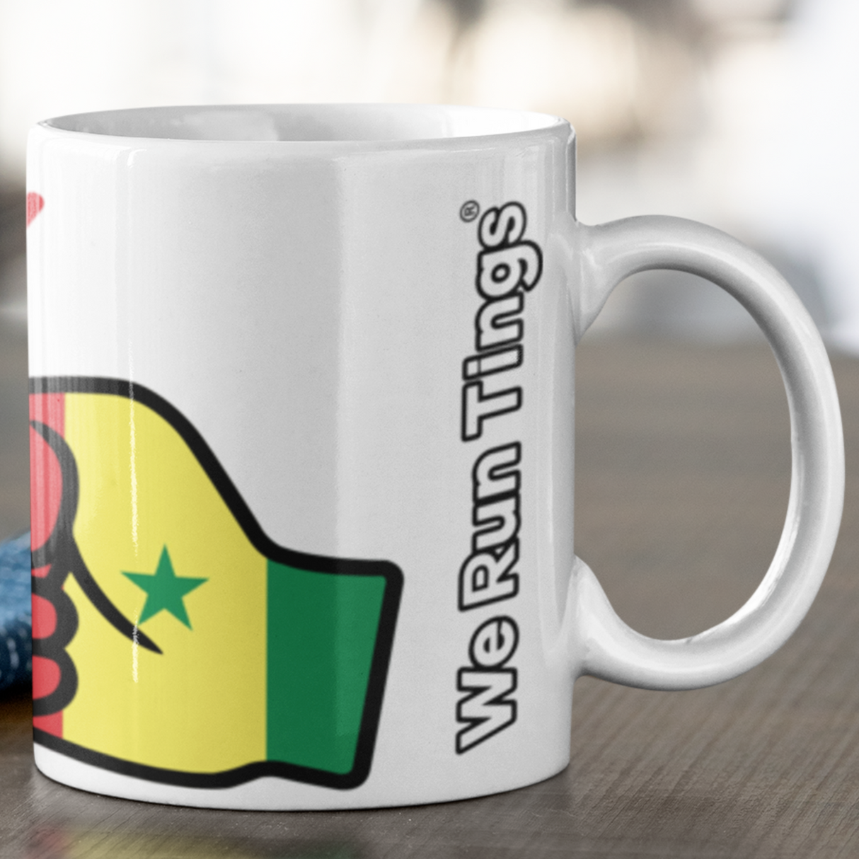 White e Run Tings Senegal themed mug with colorful design and text on a wooden surface