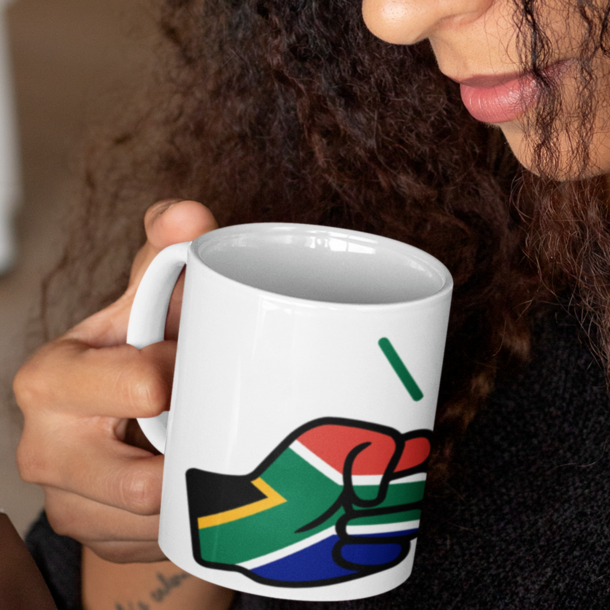 Woman holding a white ceramic We Run Tings, South Africa mug within the logo