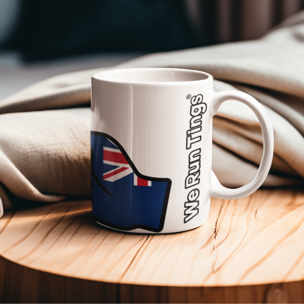 We Run Tings, Turks and Caicos, Caribbean Themed, Tea, Coffee Ceramic Mug, Cup, White, 11oz Classic Drinkware Washable Reusable Reuse Tumbler Patriotic. Side view showing wording on a wooden surface with a blurred background