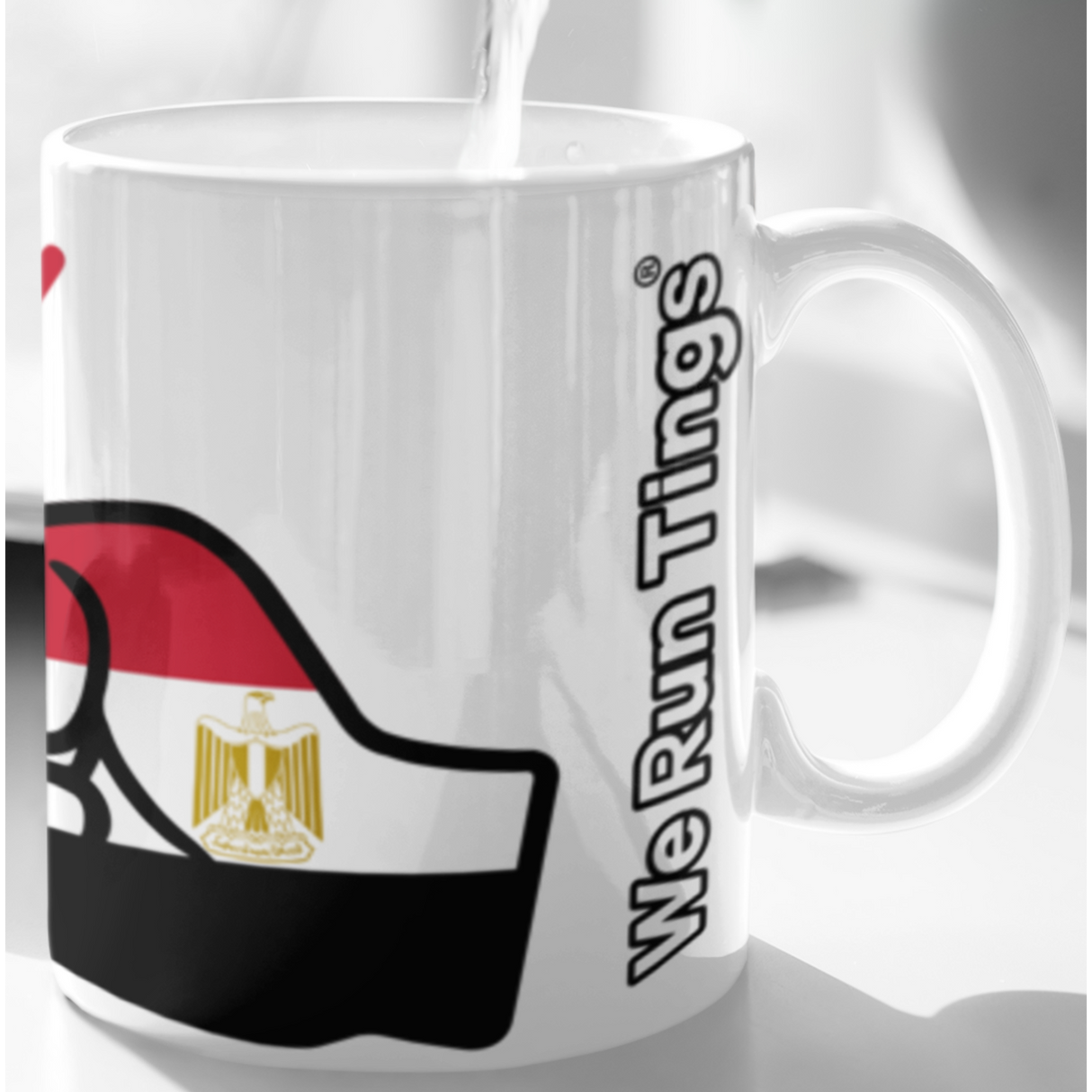 Mug with Egyptian flag design and 'We Run Things' text being filled with water.