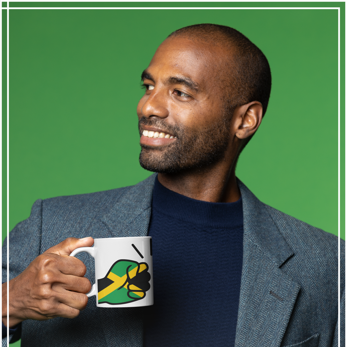 Man holding a Jamaica themed mug with a fist design against a green background