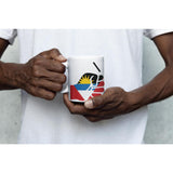 Man wearing a white t-shirt holding a white ceramic We Run Tings Antigua coffee tea mug