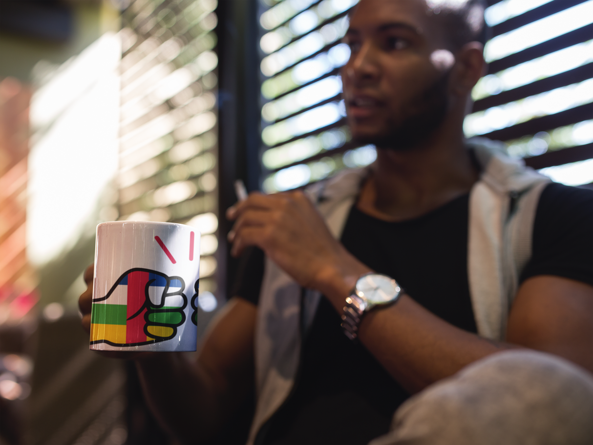Man wearing a watch holding a We Run Tings Central African Republic (CAR) Mug
with a colorful design, blurred background
