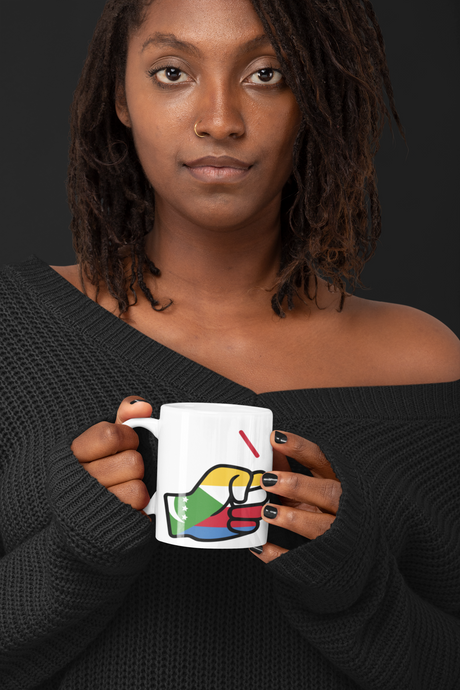 African Woman holding a We Run Tings mug with a colorful Comoros Flag themed coffee mug against a dark background