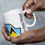 Person holding a white We Run Tings, St Lucia, St. Lucian Caribbean Themed, Tea, Coffee Ceramic Mug, Cup, 11oz Classic Drinkware Washable Reusable Reuse Glossy Tumbler Patriotic mug with a logo and text on a gray background