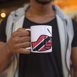 Man holding a We Run Tings, Trinidad & Tobago, Caribbean Themed, Tea, Coffee White Ceramic Mug, Cup, White, 11oz Drinkware Glossy Washable Reusable Reuse Tumbler Classic. mug with a graphic design of a hand holding a flag, blurred background
