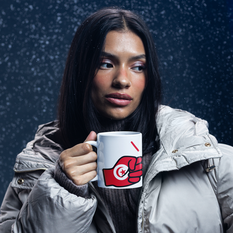 Woman holding a white mug featuring the flag of Tunisia against a dark background