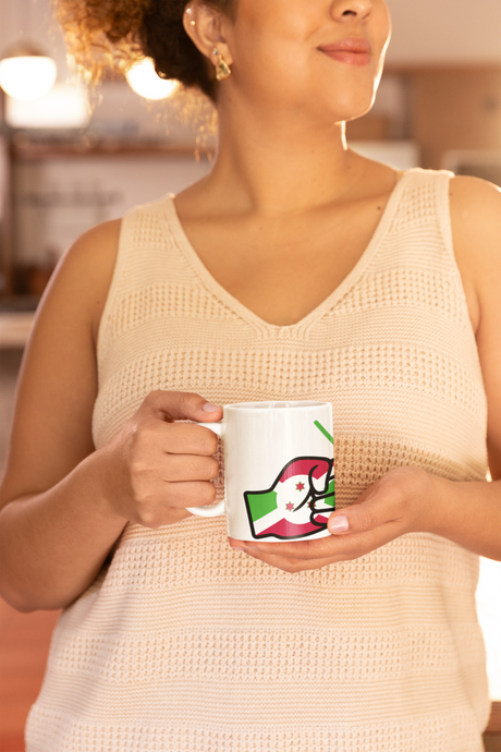 Woman wearing a light-colored sleeveless top holding a mug with We Run Tings Logo and a flag of Burundi design