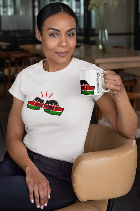 Woman holding a We Run Tings Kenya themed coffee mug with a design of the Kenyan flag, sitting in a casual setting.
