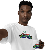 Man wearing a We Run Tings white t-shirt with a design holding a We Run Tings South African themed mug with a similar design on a white background