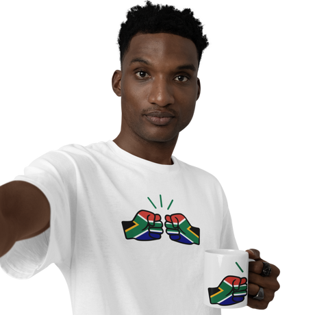 Man wearing a We Run Tings white t-shirt with a design holding a We Run Tings South African themed mug with a similar design on a white background