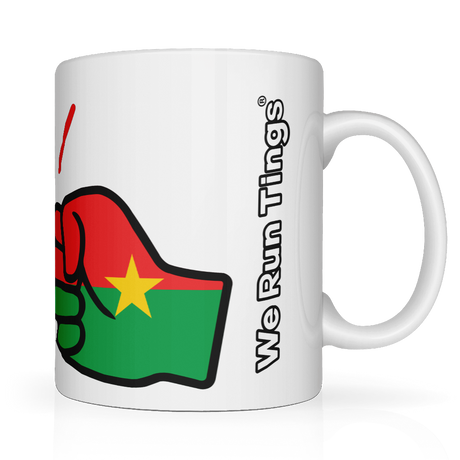 Side view. White mug with a graphic fist of the flag of Burkina Faso Mug. White ceramic glossy cup featuring the flag of Burkina Faso graphic and 'We Run Tings' text on a white background