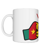 Glossy white ceramic mug featuring a patriotic We Run Tings logo with two fists displaying the flag of Cameroon. Left view