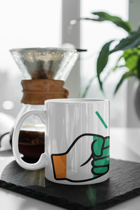 We Run Tings Cote d’Ivoire/Ivory Coast coffee Mug placed on a dark surface with a blurred background.