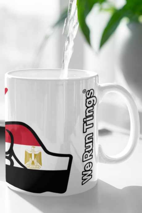 Mug with Egyptian flag design and 'We Run Things' text being filled with water.