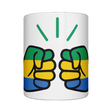 A glossy white We Run Tings Gabon ceramic mug with a design featuring the brand logo with the Gabonese flag colors and the brand 'We Run Tings'. on a white bakground.