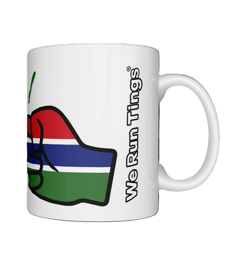 A glossy white ceramic We Run Tings Gambia Mug with a graphic design of a fist and the colors of the flag of Gambia. Front view