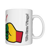 White ceramic We Run Tings Guinea mug with a colorful fist graphic and 'We Run Ting' text on a white background