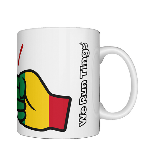 White ceramic We Run Tings Guinea mug with a colorful fist graphic and 'We Run Ting' text on a white background
