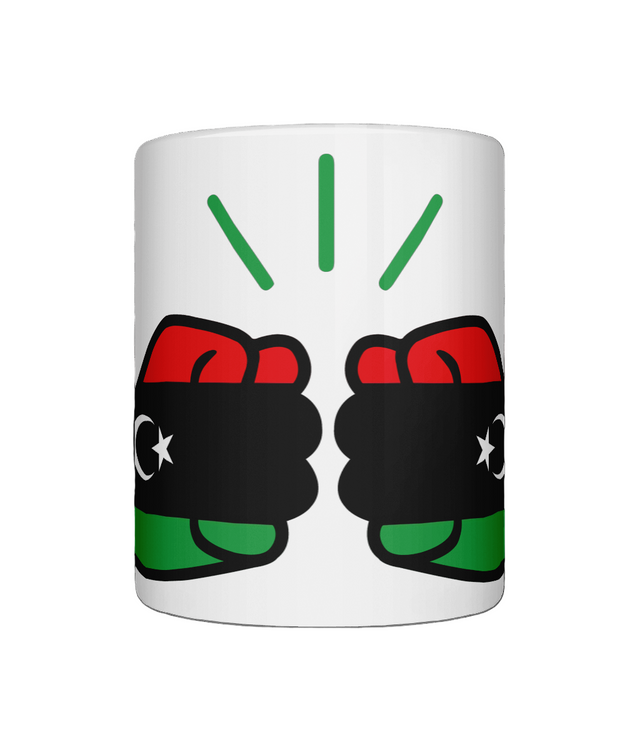A glossy white ceramic mug We Run Tings Libya mug with a graphic design featuring clenched fists and the colours of the Libyan flag. Front view on a white background