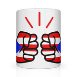 A glossy white We Run Tings ceramic mug with a graphic design of a fist and the colors of the Puerto Rican flag.