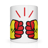 A glossy white ceramic mug with a hand-painted design featuring a fist and the text 'We Run Tings' in a bold, red and yellow color scheme representing the African country of Senegal