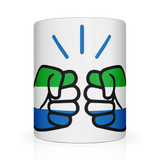 A glossy white ceramic coffee, tea mug with a graphic design of a fist featuring the We Run Tings Logo and the colors of the Sierra Leone flag, indicating a theme or message related to the country.