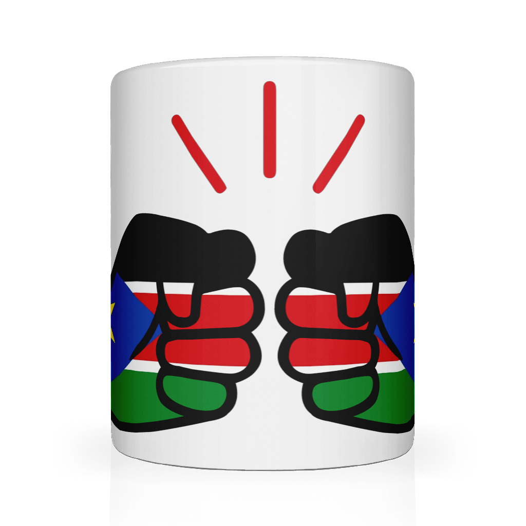 A white We Run Tings ceramic mug with a glossy finish featuring a graphic design of clenched fists and the flag of South Sudan. Front view.