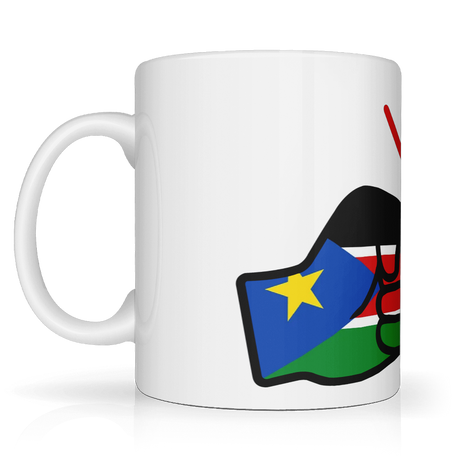 A white We Run Tings ceramic mug with a glossy finish featuring the brand logo design of clenched fists and the flag of South Sudan. Side view.