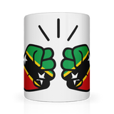 A white ceramic mug with a glossy finish featuring a graphic design of two clenched fists in green, yellow, and red, representing St. Kitts and Nevis, with a background of stars.