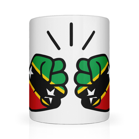 A white ceramic mug with a glossy finish featuring a graphic design of two clenched fists in green, yellow, and red, representing St. Kitts and Nevis, with a background of stars.