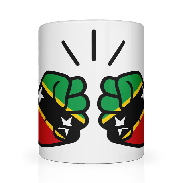 A white ceramic mug with a glossy finish featuring a graphic design of two clenched fists in green, yellow, and red, representing St. Kitts and Nevis, with a background of stars.