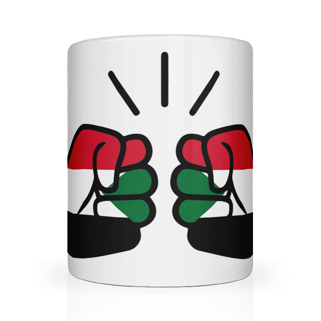 A glossy white ceramic We Run Tings, Sudan coffee, tea mug with a design of two fists on the side, representing the brand We Run Tings, and the flag of Sudan.