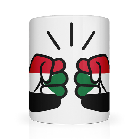 A glossy white ceramic We Run Tings, Sudan coffee, tea mug with a design of two fists on the side, representing the brand We Run Tings, and the flag of Sudan.