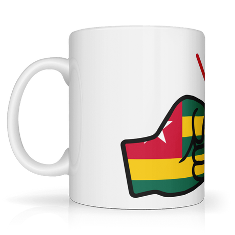 White ceramic mug featuring a bold “We Run Tings” design with two raised fists wrapped in the Togo flag colors, accented by red graphic lines above, symbolizing strength, unity, and cultural pride. Side view on a white background