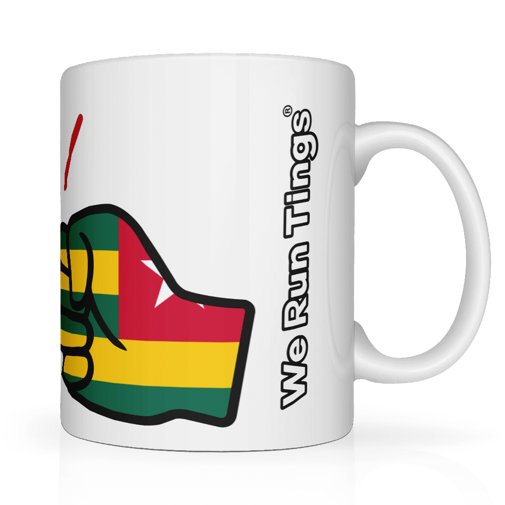 White ceramic “We Run Tings” mug featuring a raised fist wrapped in the Togo flag colors, with the brand name printed vertically on the side, symbolizing empowerment, unity, and cultural pride.