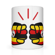 A glossy white ceramic We Run Tings, Uganda tea, coffee mug with a graphic design of clenched fists in yellow, red, and black colors, representing the 'We Run Tings' brand.
