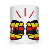 A glossy white ceramic We Run Tings, Uganda tea, coffee mug with a graphic design of clenched fists in yellow, red, and black colors, representing the 'We Run Tings' brand.