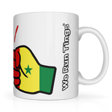 White mug with a fist holding a Senegal flag design and 'We Run Tings' text on a white background. Side view