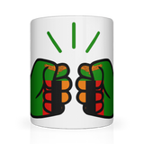 A white We Run Tings, Zambia ceramic mug with a graphic design of a fist holding a tea bag, surrounded by a green and red pattern. Front view