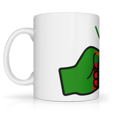 White mug with a green and red design on a white background