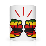 White glossy ceramic We Run Tings, Zimbabwe coffee, tea mug with red, yellow, and green design on a white background