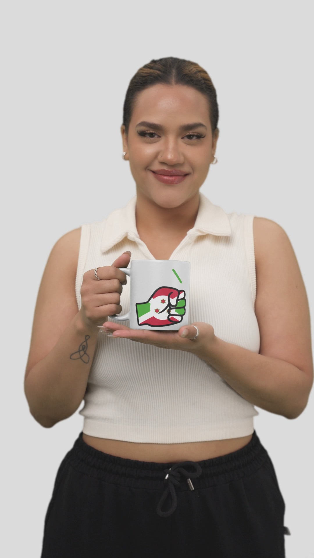 Woman smiling holding a We Run Tings Burundi themed coffee mug on a white background